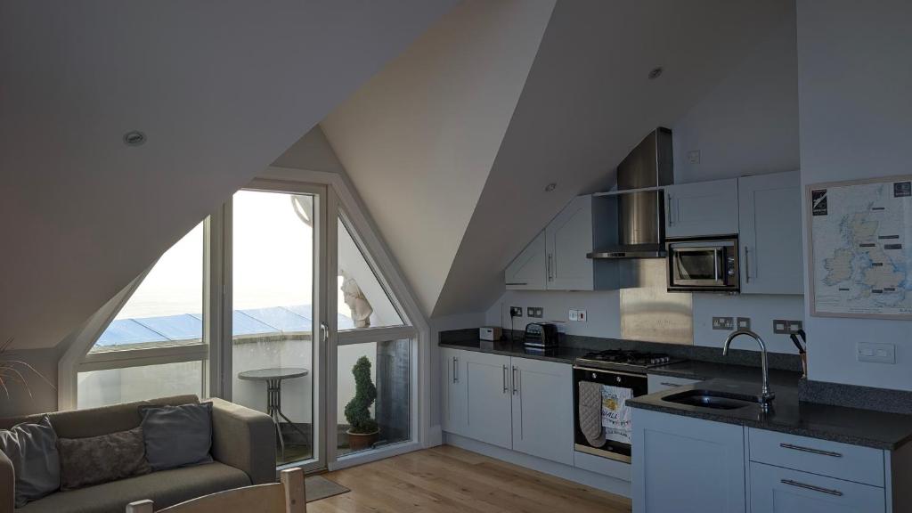 Open-plan living and kitchen at Tate Five, with sea views through the windows
