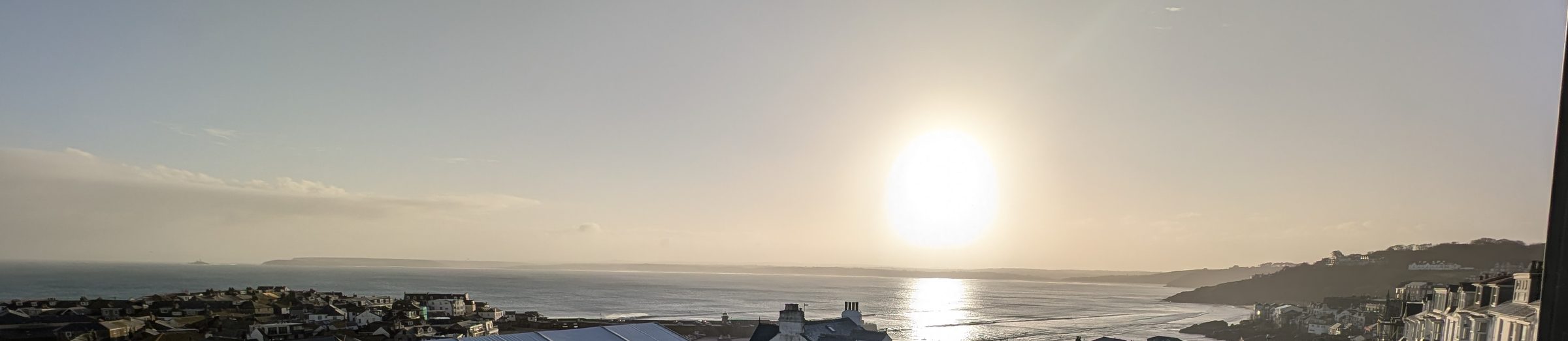 Dawn light over St Ives bay, seen from the apartment, sun rising over the headland.